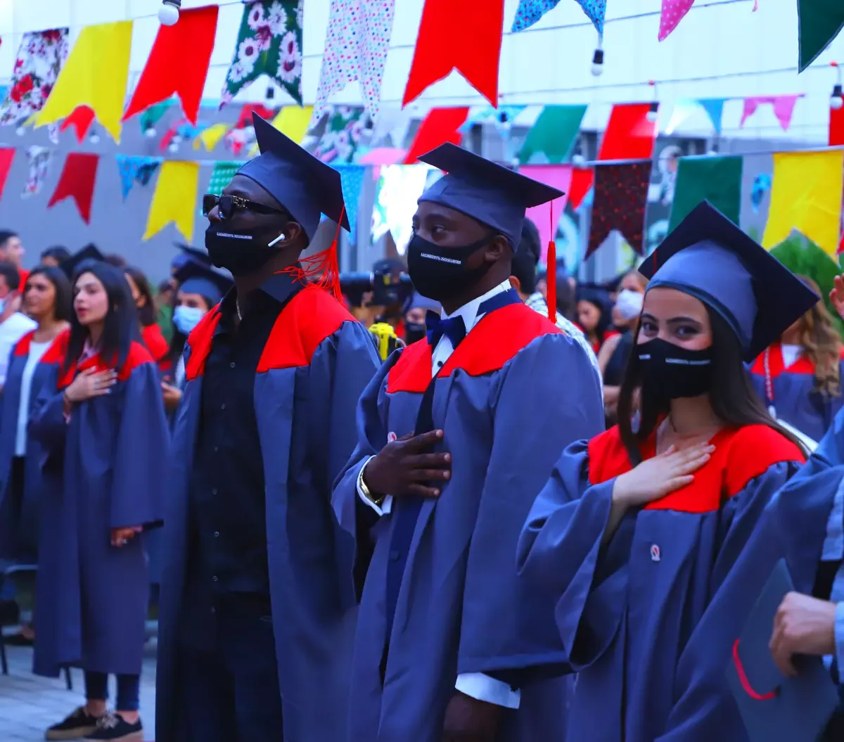 Graduates wearing caps and gowns at a university ceremony
